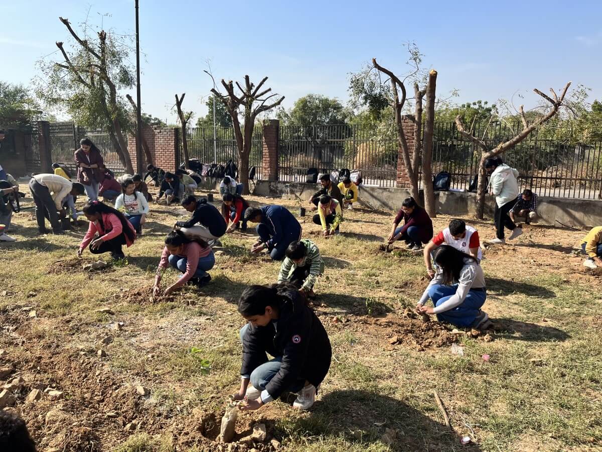Students from the Jaipur Engineering College and Research Centre (JECRC) University participating in a tree plantation drive on campus.