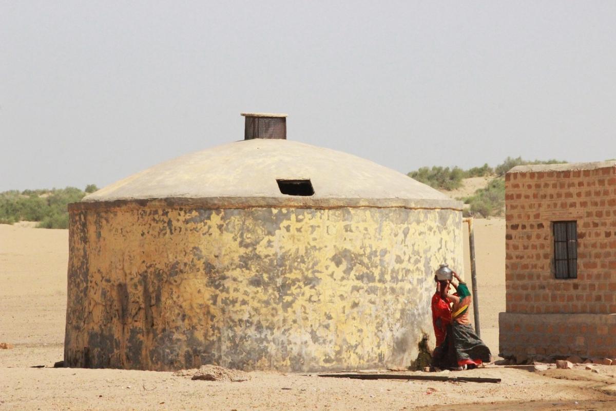 Women collecting water from a Ground Level Reservoir (GLR)