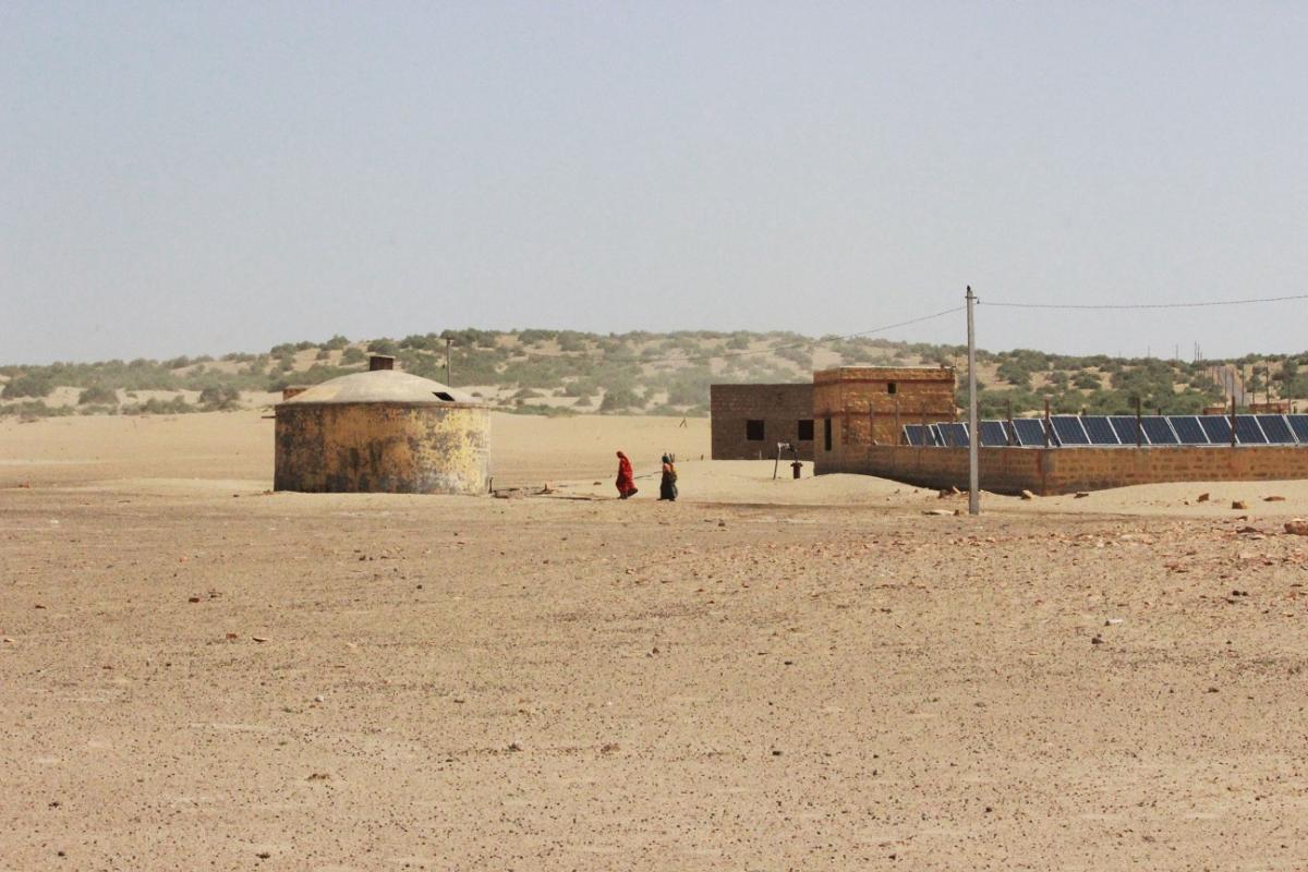 Women on their way to collect water from a GLR. Water supply here is powered by a solar unit.