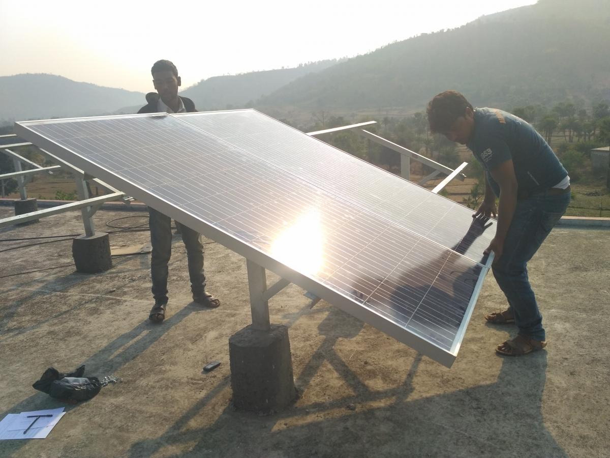Figure 2: Team at work installing the 15kWp solar PV system on the roof of the hospital in 2017
